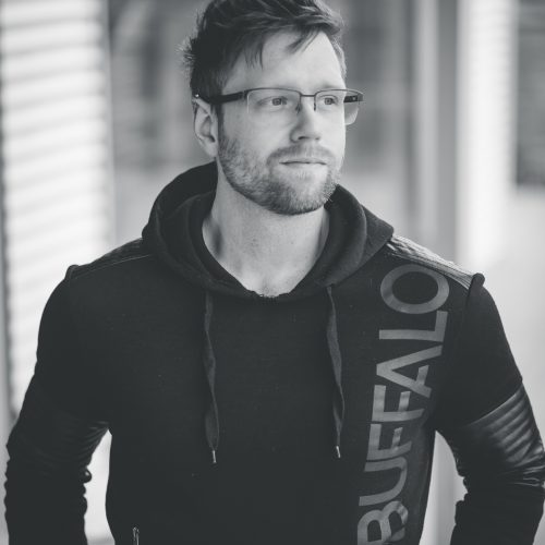 Image of the artist Devon Regular standing front on